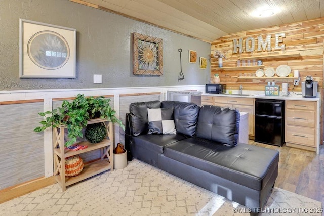 62141 E 313th Rd Unit 3, Grove, OK 74344 - living room with wet bar, light wood-style floors, wooden walls, wood ceiling, and lofted ceiling