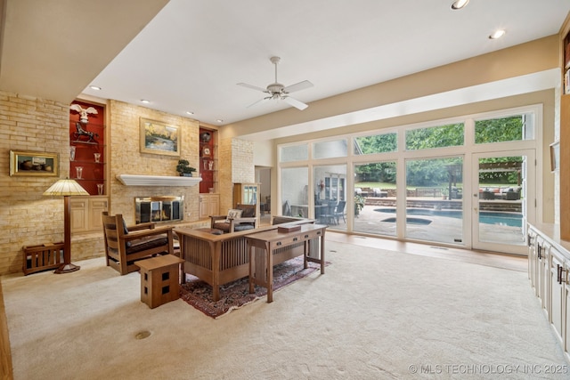 3431 E 96th Pl, Tulsa, OK 74137 - living room featuring a fireplace, ceiling fan, recessed lighting, light carpet, and built in shelves