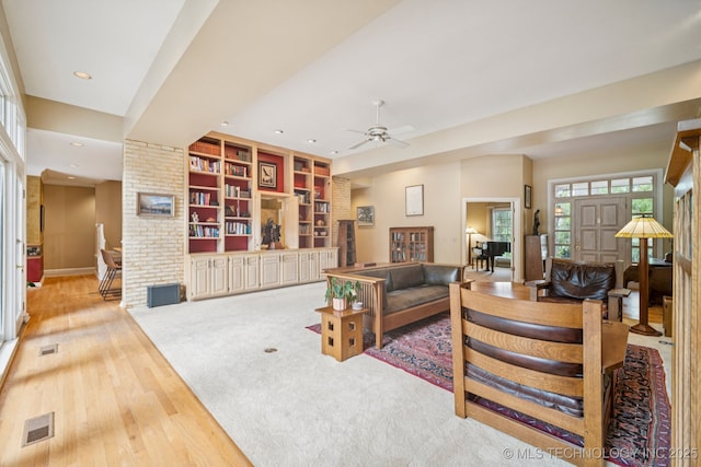 3431 E 96th Pl, Tulsa, OK 74137 - living room featuring light wood-style flooring, a ceiling fan, recessed lighting, a brick fireplace, and built in shelves