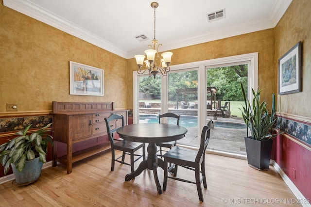 3431 E 96th Pl, Tulsa, OK 74137 - dining area featuring crown molding, light wood finished floors, and a chandelier