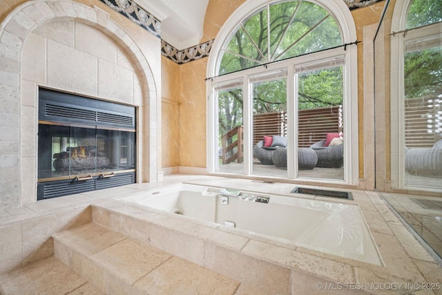 3431 E 96th Pl, Tulsa, OK 74137 - full bath featuring a tub with jets and a tile fireplace