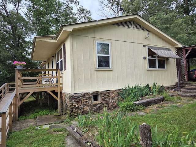 92133 S 4676th Rd, Bunch, OK 74931 - view of side of home with a wooden deck, stairs, and stone siding