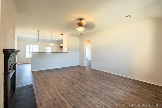 2708 W Fredericksburg St, Broken Arrow, OK 74011 - unfurnished living room featuring dark wood finished floors, arched walkways, ceiling fan, recessed lighting, and a fireplace