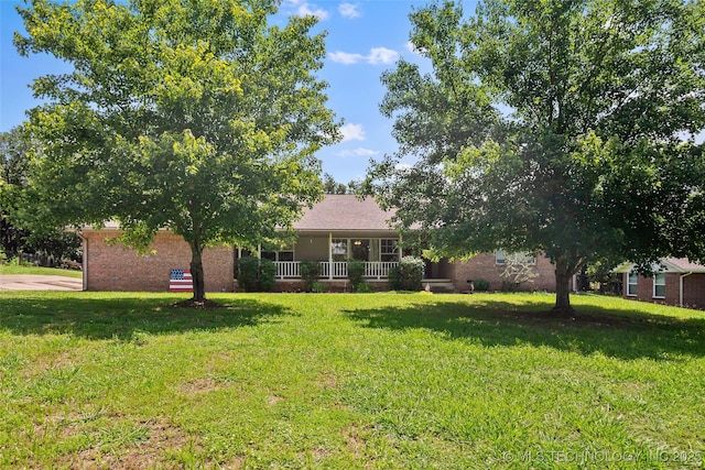 17997 S 4160th Rd W, Claremore, OK 74017 - view of front of house with a front yard, brick siding, and covered porch