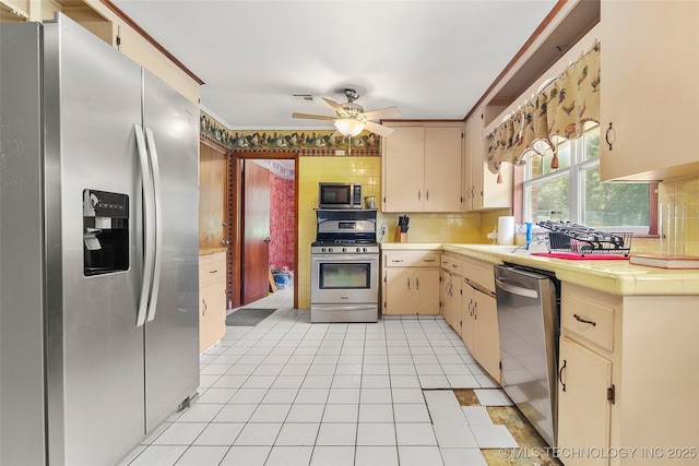 17997 S 4160th Rd W, Claremore, OK 74017 - kitchen with stainless steel appliances, tasteful backsplash, a ceiling fan, and light tile patterned flooring