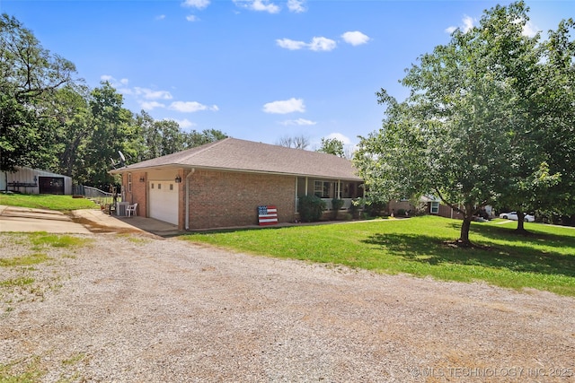17997 S 4160th Rd W, Claremore, OK 74017 - view of side of home with driveway, a garage, brick siding, and a lawn