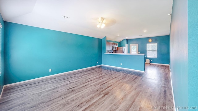 15081 S 276th E Ave, Broken Arrow, OK 74429 - unfurnished living room featuring lofted ceiling, wood finished floors, and ceiling fan