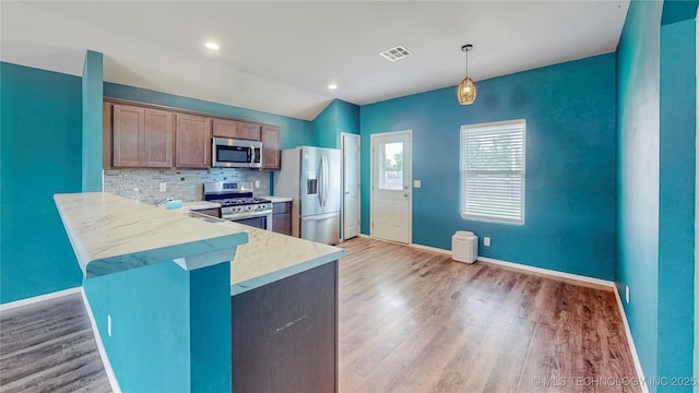 15081 S 276th E Ave, Broken Arrow, OK 74429 - kitchen featuring stainless steel appliances, light wood finished floors, backsplash, and light countertops