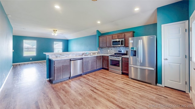 15081 S 276th E Ave, Broken Arrow, OK 74429 - kitchen with appliances with stainless steel finishes, a peninsula, light wood-type flooring, light countertops, and recessed lighting