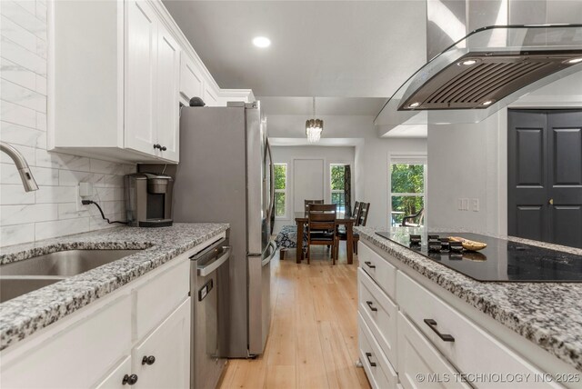 29012 E 63rd St, Broken Arrow, OK 74014 - kitchen with black electric stovetop, wall chimney range hood, dishwasher, white cabinetry, and decorative backsplash