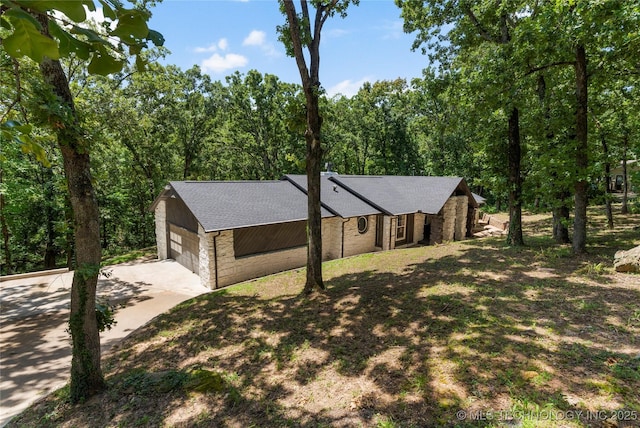 29012 E 63rd St, Broken Arrow, OK 74014 - view of front of home featuring concrete driveway, a shingled roof, a garage, and brick siding