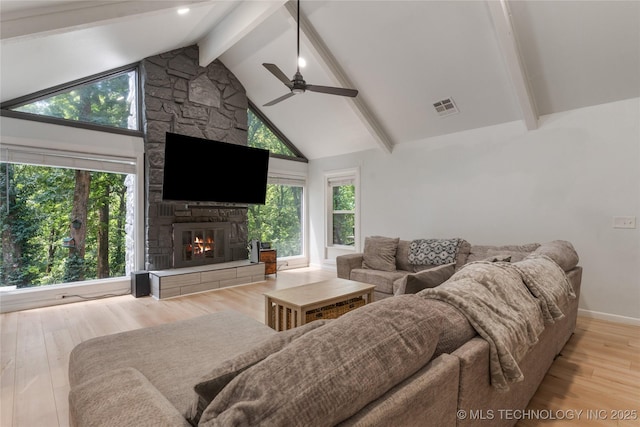 29012 E 63rd St, Broken Arrow, OK 74014 - living room with ceiling fan, light wood-style floors, beam ceiling, a stone fireplace, and high vaulted ceiling