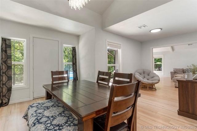 29012 E 63rd St, Broken Arrow, OK 74014 - dining space featuring healthy amount of natural light, light wood finished floors, and a chandelier