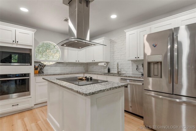 29012 E 63rd St, Broken Arrow, OK 74014 - kitchen with stainless steel appliances, island range hood, decorative backsplash, light wood-style flooring, and recessed lighting