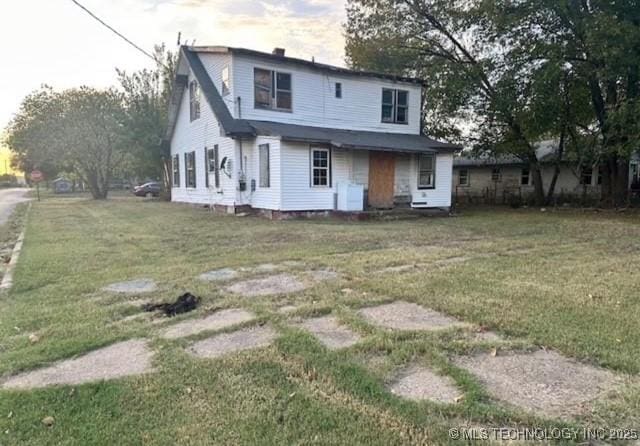 1101 N Collins Ave, Okmulgee, OK 74447 - back of property with a yard and a chimney