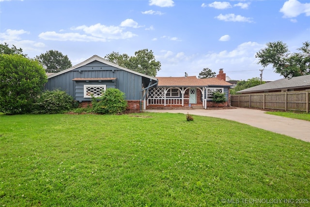 5225 S Toledo Ave, Tulsa, OK 74135 - view of front of home with board and batten siding, brick siding, driveway, a chimney, and covered porch
