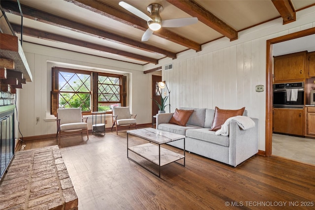 5225 S Toledo Ave, Tulsa, OK 74135 - living room featuring a ceiling fan, wood finished floors, and beam ceiling