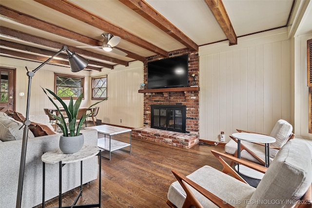 5225 S Toledo Ave, Tulsa, OK 74135 - living area with dark wood-type flooring, beamed ceiling, ceiling fan, and a fireplace