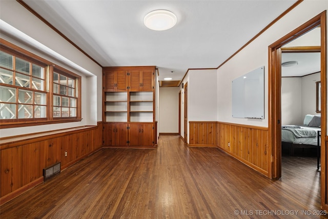 5225 S Toledo Ave, Tulsa, OK 74135 - spare room featuring wainscoting, wood finished floors, wooden walls, and crown molding