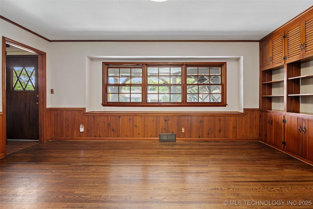 5225 S Toledo Ave, Tulsa, OK 74135 - unfurnished room with a wainscoted wall, ornamental molding, dark wood-style floors, and wood walls