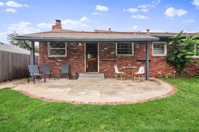 5225 S Toledo Ave, Tulsa, OK 74135 - rear view of property featuring a chimney, a patio area, brick siding, and entry steps