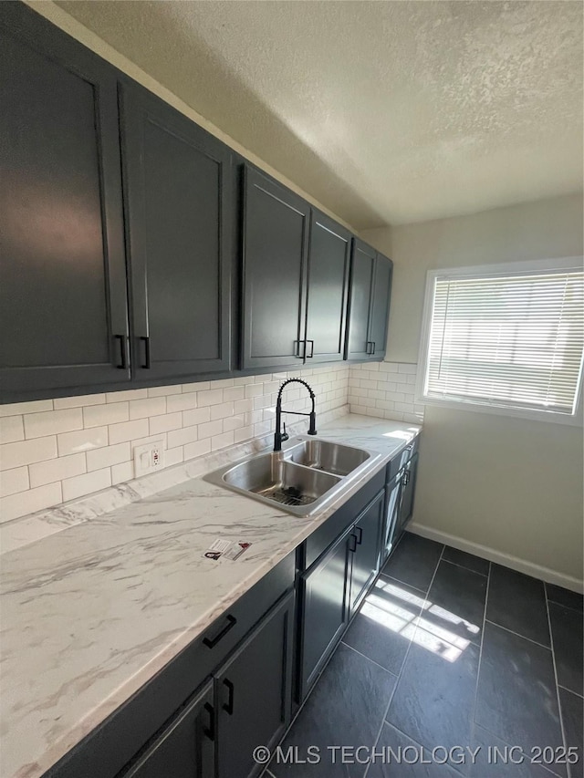 26 E 45th St N, Tulsa, OK 74106 - kitchen with a textured ceiling, backsplash, and dark tile patterned flooring