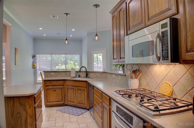 14230 S Urbana Ave, Bixby, OK 74008 - kitchen with appliances with stainless steel finishes, brown cabinetry, decorative backsplash, a peninsula, and crown molding