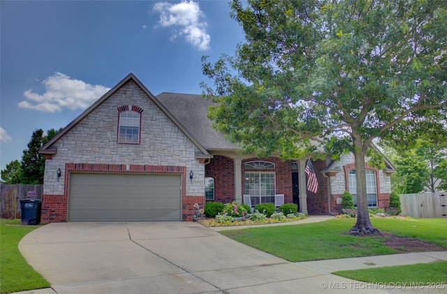 14230 S Urbana Ave, Bixby, OK 74008 - view of front of house featuring stone siding, driveway, brick siding, and a shingled roof