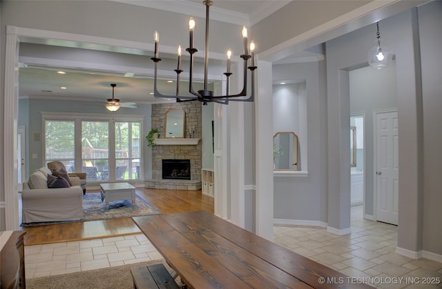 14230 S Urbana Ave, Bixby, OK 74008 - living room featuring ceiling fan, a stone fireplace, and ornamental molding
