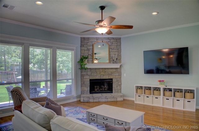 14230 S Urbana Ave, Bixby, OK 74008 - living area with ceiling fan, crown molding, wood finished floors, and a stone fireplace