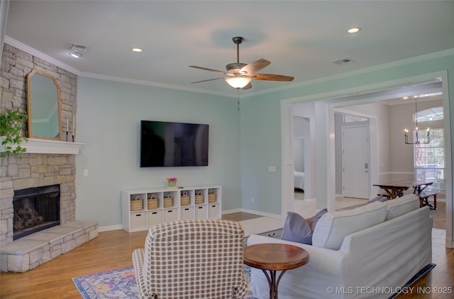 14230 S Urbana Ave, Bixby, OK 74008 - living area with ceiling fan, wood finished floors, crown molding, a stone fireplace, and a chandelier