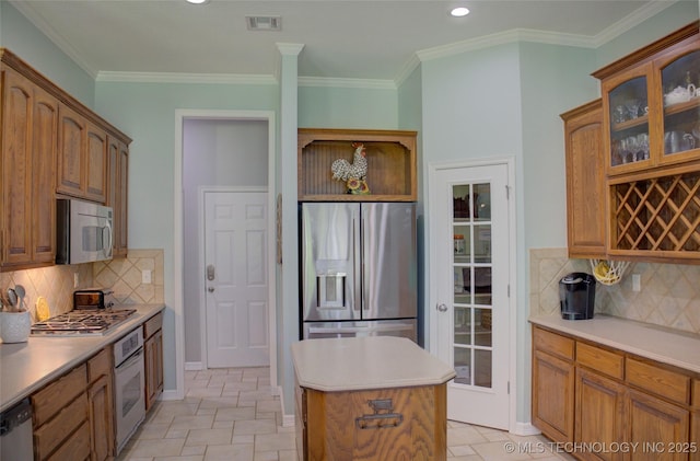 14230 S Urbana Ave, Bixby, OK 74008 - kitchen with stainless steel appliances, a kitchen island, glass insert cabinets, backsplash, and light countertops