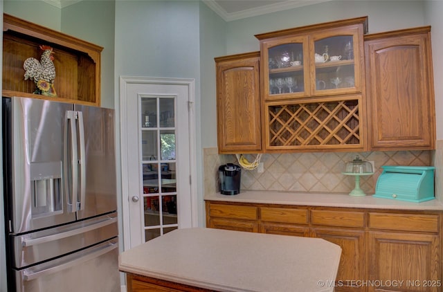 14230 S Urbana Ave, Bixby, OK 74008 - kitchen featuring stainless steel refrigerator with ice dispenser, ornamental molding, light countertops, backsplash, and glass insert cabinets