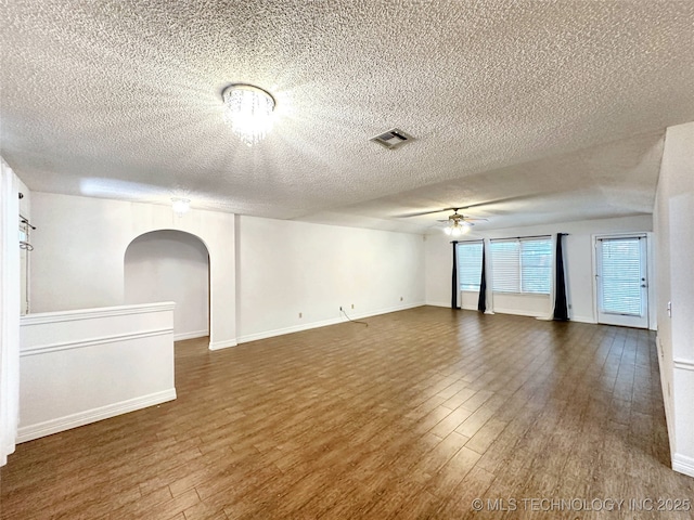 6223 S Cedar Pl, Broken Arrow, OK 74011 - unfurnished room featuring ceiling fan, wood finished floors, a textured ceiling, and arched walkways