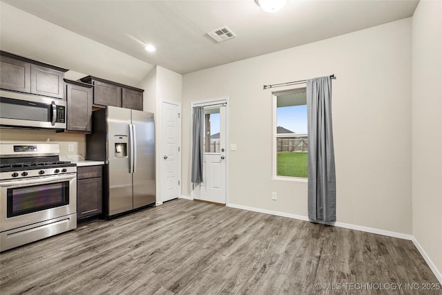 23561 E 114th Ct, Broken Arrow, OK 74014 - kitchen with stainless steel appliances, light wood finished floors, dark brown cabinets, and light countertops