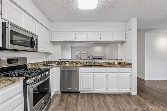 8316 E 81st Pl, Tulsa, OK 74133 - kitchen featuring stainless steel appliances, dark wood finished floors, a textured ceiling, white cabinetry, and dark stone countertops