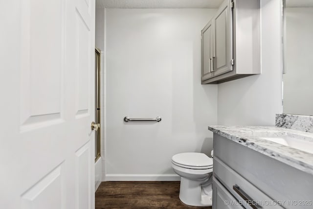 8316 E 81st Pl, Tulsa, OK 74133 - bathroom with vanity, wood finished floors, shower / bath combination, and a textured ceiling