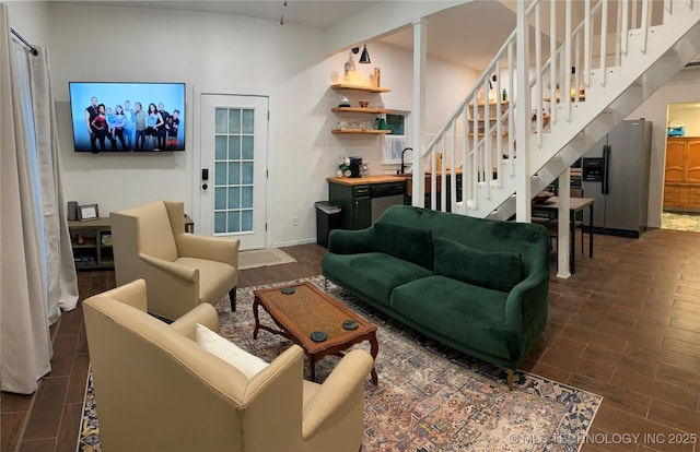 321 E 10th St, Pawhuska, OK 74056 - living room with stairs and dark wood-style flooring