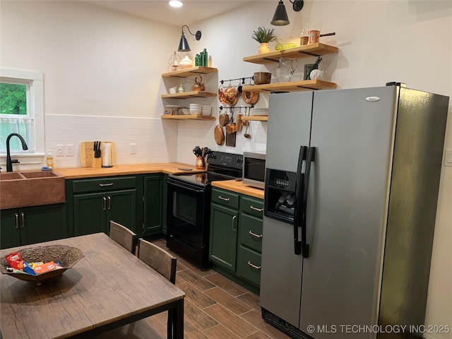 321 E 10th St, Pawhuska, OK 74056 - kitchen featuring stainless steel appliances, green cabinets, backsplash, open shelves, and recessed lighting