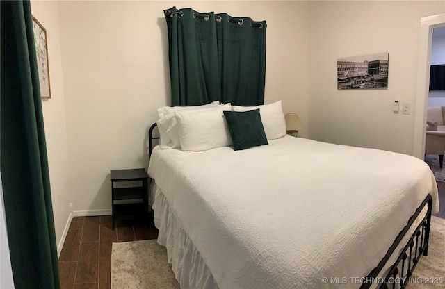 321 E 10th St, Pawhuska, OK 74056 - bedroom featuring wood finished floors and baseboards