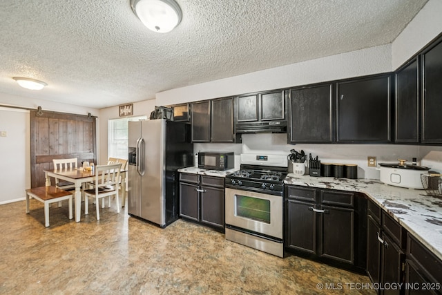 13728 S Birch St, Glenpool, OK 74033 - kitchen featuring stainless steel appliances, exhaust hood, a textured ceiling, a barn door, and dark cabinetry
