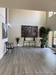4822 S Quaker Ave, Tulsa, OK 74105 - unfurnished living room with a towering ceiling and wood finished floors