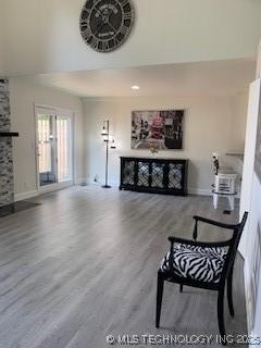 4822 S Quaker Ave, Tulsa, OK 74105 - living room with a high ceiling, wood finished floors, and a fireplace