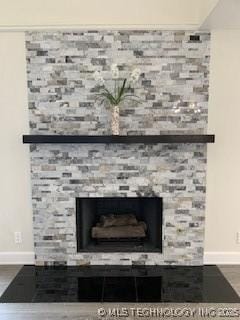 4822 S Quaker Ave, Tulsa, OK 74105 - detailed view of a stone fireplace and wood finished floors
