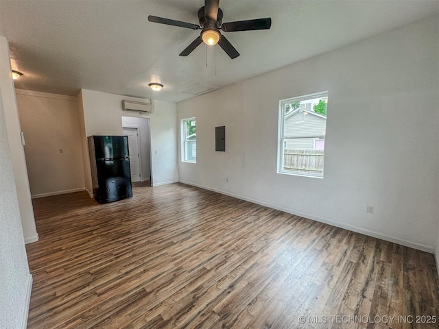 916 Coy Ave, Tahlequah, OK 74464 - unfurnished living room with a wall mounted AC, wood finished floors, a ceiling fan, and electric panel