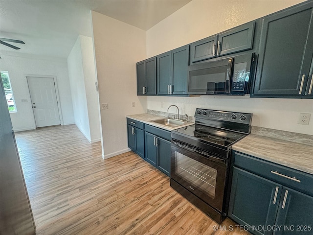 916 Coy Ave, Tahlequah, OK 74464 - kitchen featuring black appliances, a ceiling fan, light wood-type flooring, and light countertops