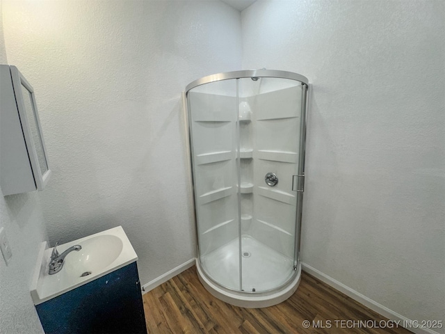 916 Coy Ave, Tahlequah, OK 74464 - bathroom with wood finished floors, a shower stall, and vanity