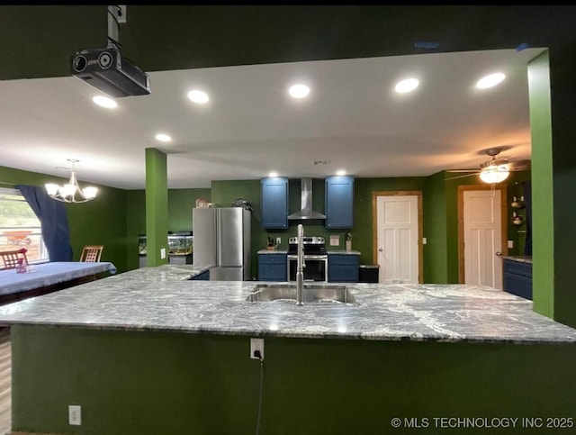 23422 E 79th St S, Broken Arrow, OK 74014 - kitchen featuring wall chimney exhaust hood, stainless steel appliances, a chandelier, a large island with sink, and blue cabinets