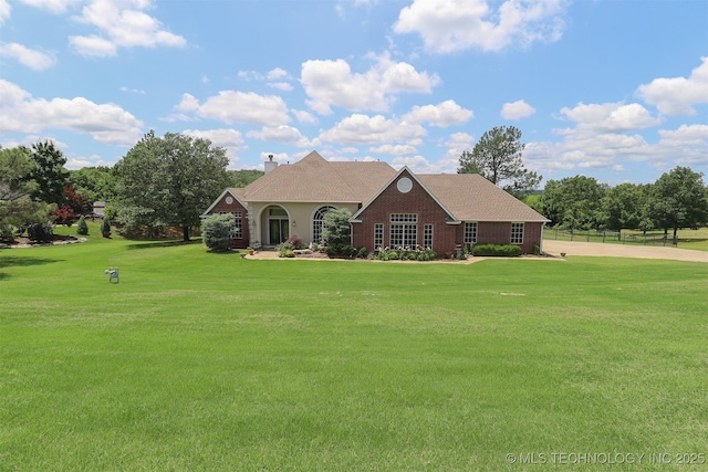 12310 S Mesa Rd, Sapulpa, OK 74066 - view of front of house featuring a front lawn, a chimney, and brick siding