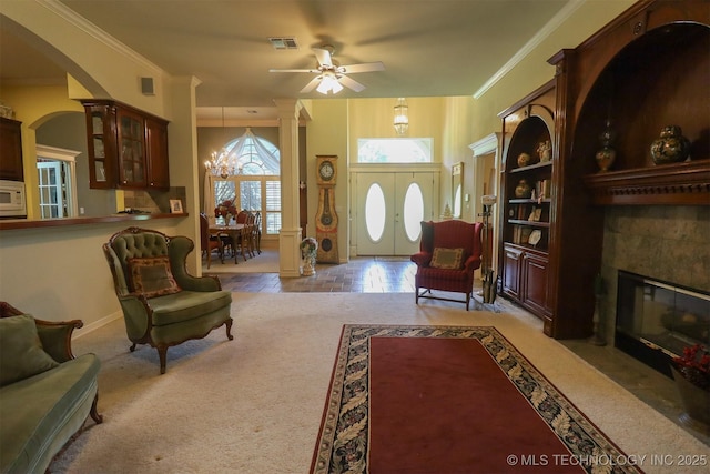 12310 S Mesa Rd, Sapulpa, OK 74066 - living area featuring a fireplace with flush hearth, ceiling fan, a chandelier, arched walkways, and ornate columns
